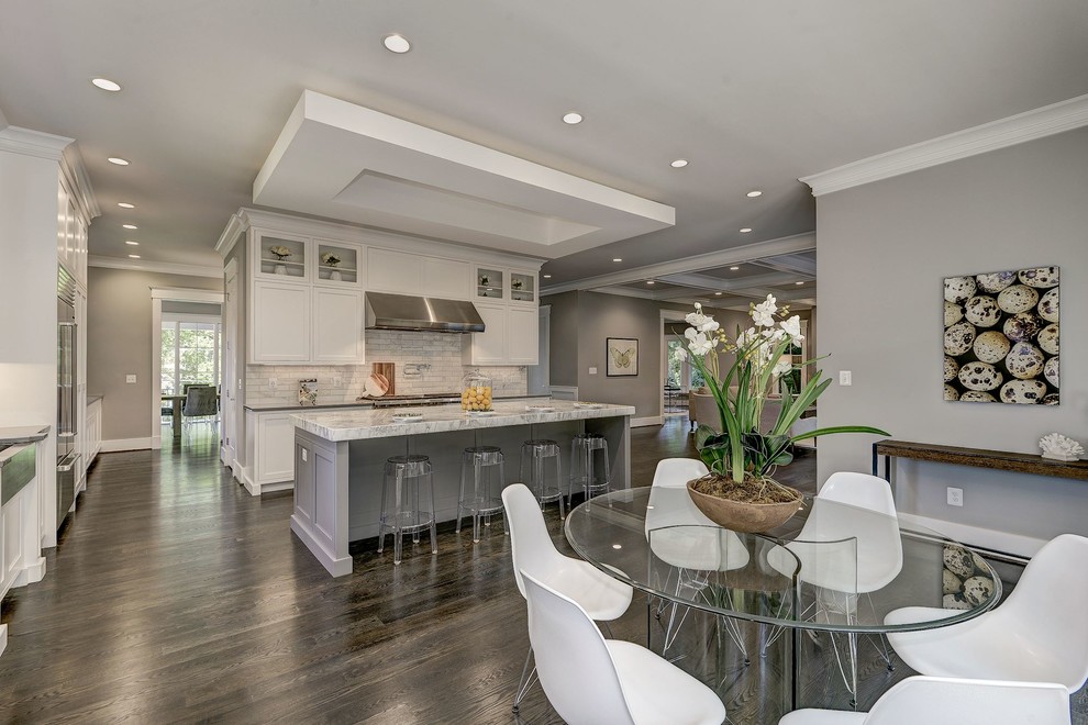 Design ideas for an expansive contemporary l-shaped open plan kitchen in DC Metro with a farmhouse sink, shaker cabinets, white cabinets, quartz benchtops, multi-coloured splashback, marble splashback, stainless steel appliances, dark hardwood floors, with island, brown floor and grey benchtop.
