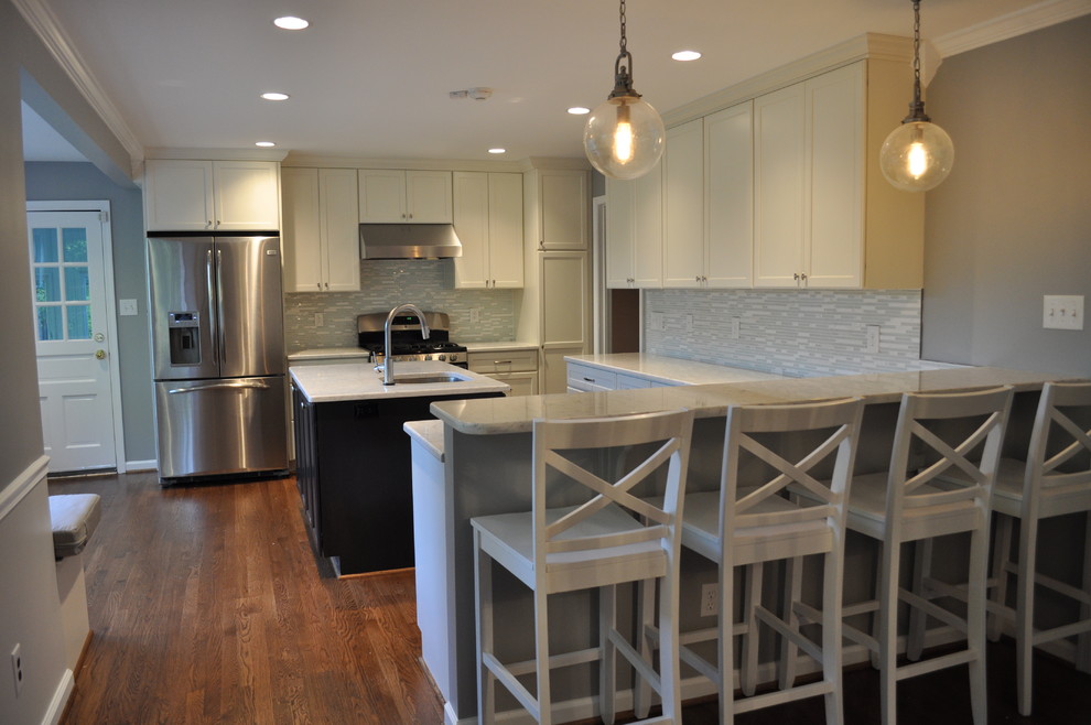 Eat-in kitchen - large transitional u-shaped medium tone wood floor eat-in kitchen idea in DC Metro with a single-bowl sink, recessed-panel cabinets, white cabinets, marble countertops, blue backsplash, glass tile backsplash, stainless steel appliances and an island