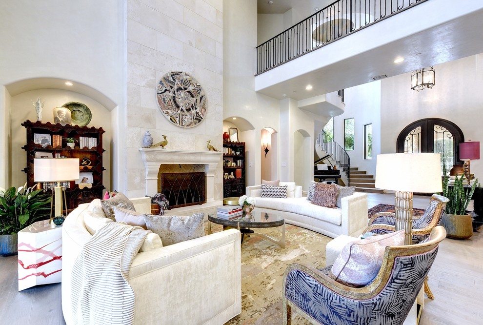 Traditional formal open concept living room in Austin with white walls, a standard fireplace, no tv and beige floor.