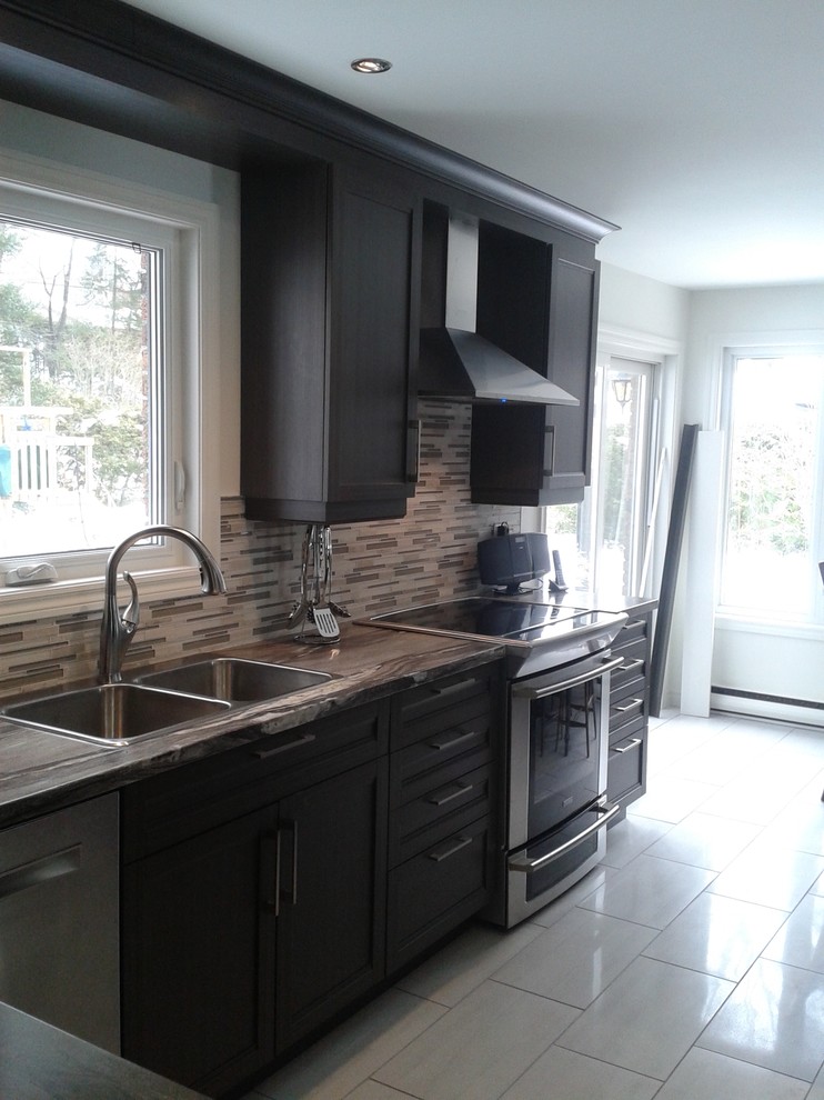 Large contemporary u-shaped open plan kitchen in Ottawa with a double-bowl sink, shaker cabinets, grey cabinets, laminate benchtops, grey splashback, glass tile splashback, stainless steel appliances, ceramic floors and a peninsula.