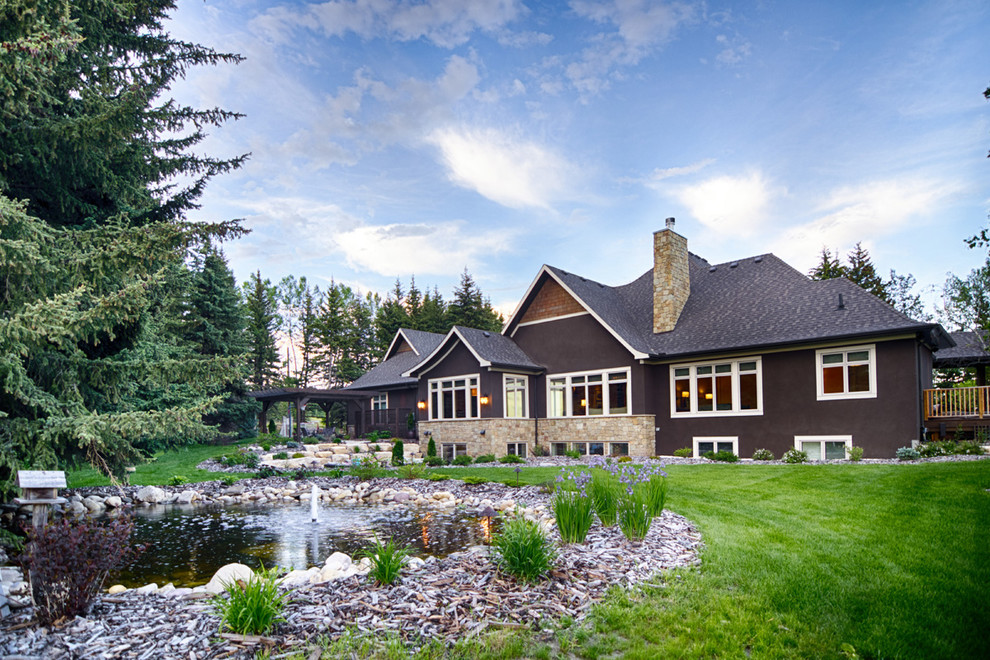 Example of a transitional home design design in Calgary