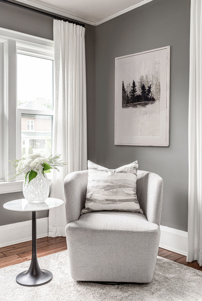 Photo of a small traditional study in Toronto with grey walls, medium hardwood flooring, no fireplace, a freestanding desk, brown floors, a wallpapered ceiling and brick walls.
