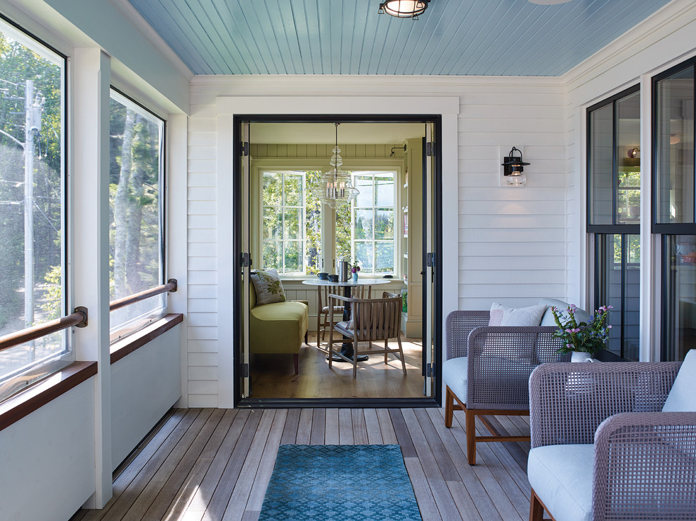 Design ideas for a beach style screened-in verandah in Portland Maine with decking and a roof extension.