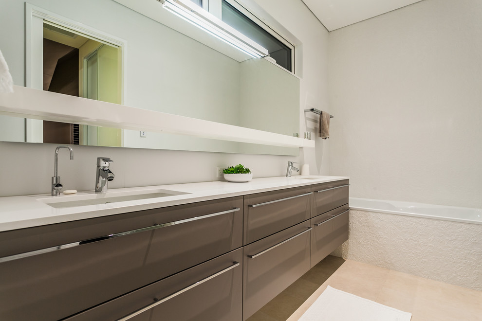 Contemporary bathroom in Perth with flat-panel cabinets, brown cabinets, an alcove tub, white walls and an undermount sink.