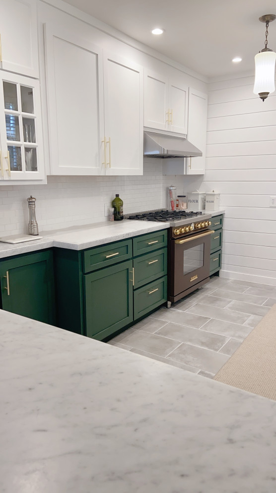 This is an example of a mid-sized modern galley eat-in kitchen in San Francisco with a farmhouse sink, flat-panel cabinets, green cabinets, marble benchtops, white splashback, ceramic splashback, stainless steel appliances, cement tiles, no island, grey floor and white benchtop.