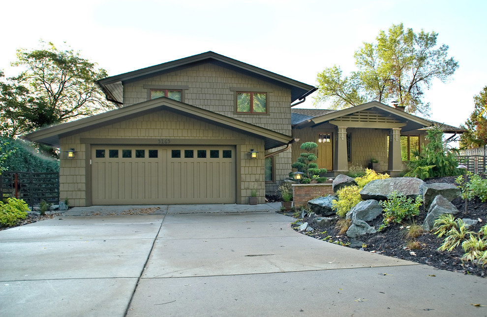 Photo of a mid-sized arts and crafts split-level green exterior in Minneapolis with wood siding.