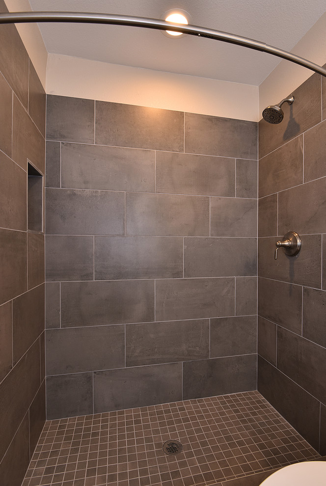 Photo of a mid-sized contemporary 3/4 bathroom in Phoenix with shaker cabinets, dark wood cabinets, an alcove shower, a two-piece toilet, gray tile, porcelain tile, beige walls, light hardwood floors, an undermount sink, zinc benchtops, brown floor and a shower curtain.