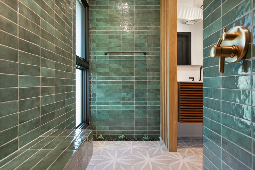 This is an example of a mid-sized contemporary bathroom in Los Angeles with medium wood cabinets, green tile, porcelain tile, white walls, porcelain floors, an integrated sink, grey floor, a double vanity and a floating vanity.
