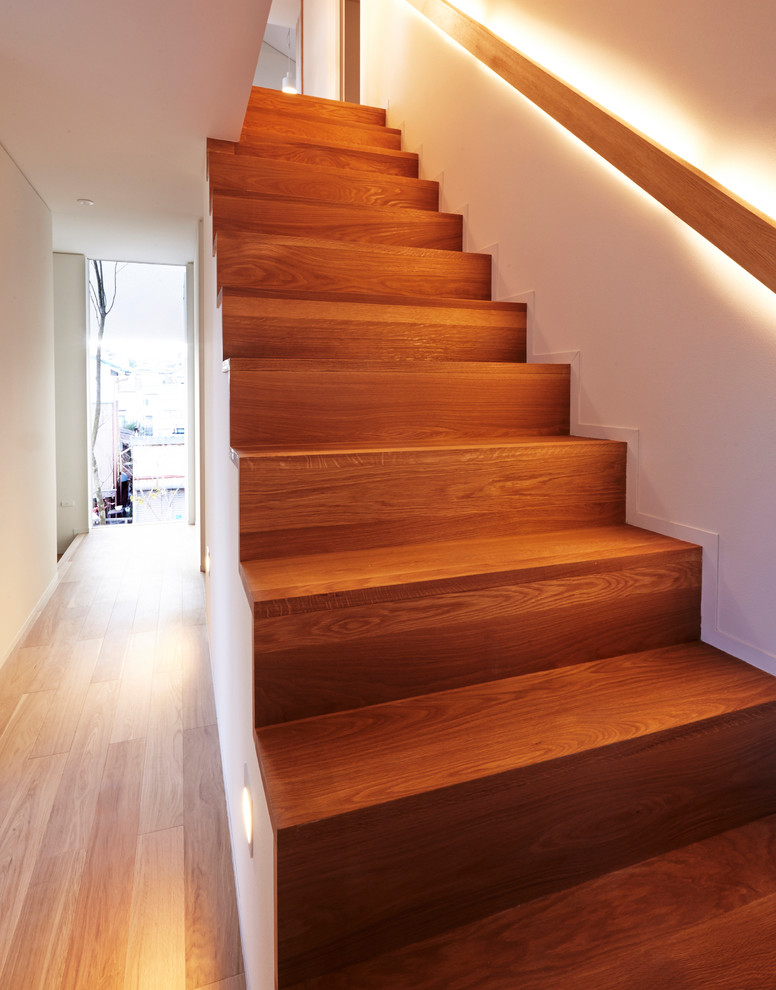 Inspiration for a small wood straight staircase in Other with wood risers and wood railing.