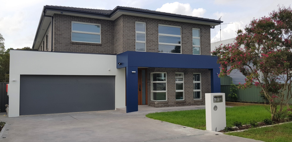 Design ideas for a large contemporary two-storey brick house exterior in Sydney with a hip roof and a tile roof.