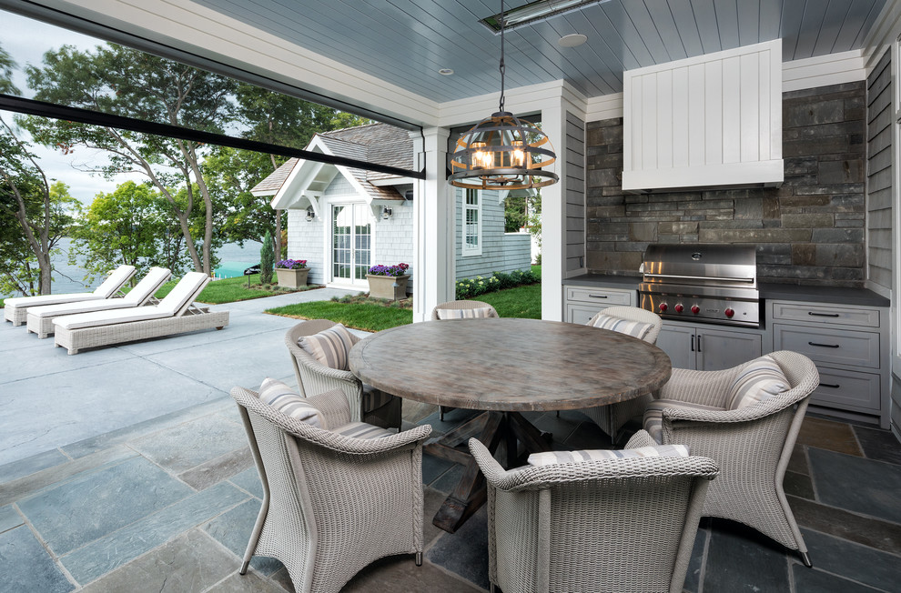 Inspiration for a beach style patio in Minneapolis with an outdoor kitchen and a roof extension.