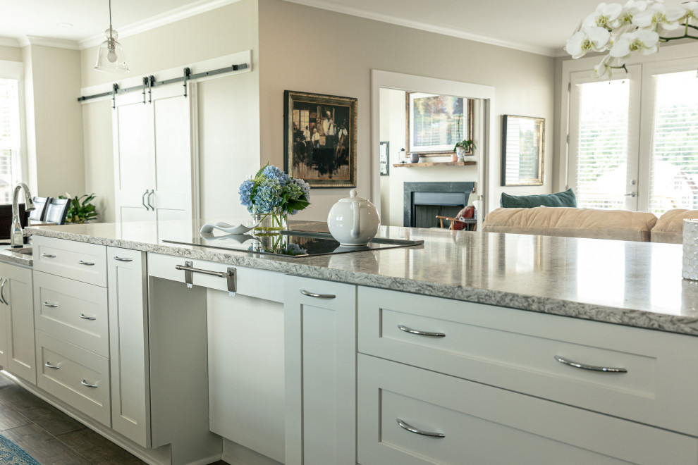 Inspiration for a mid-sized transitional galley eat-in kitchen remodel in Charlotte with flat-panel cabinets, white cabinets, quartz countertops, white backsplash, an island and multicolored countertops