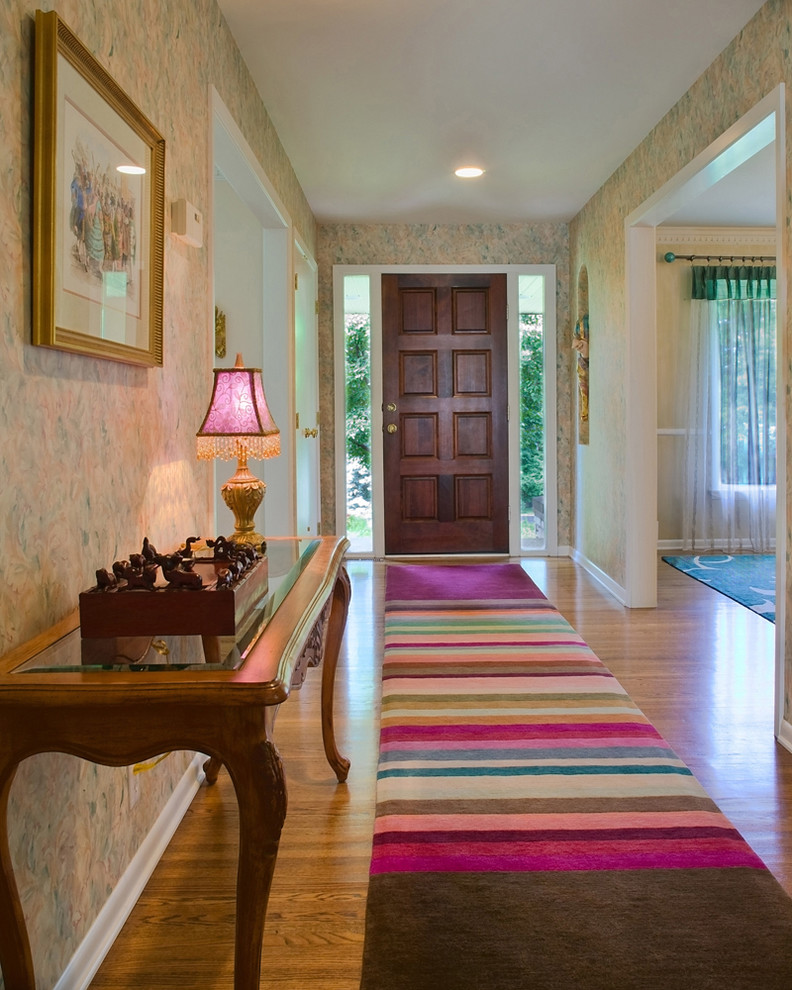 Eclectic entry hall in Raleigh with a single front door and a dark wood front door.