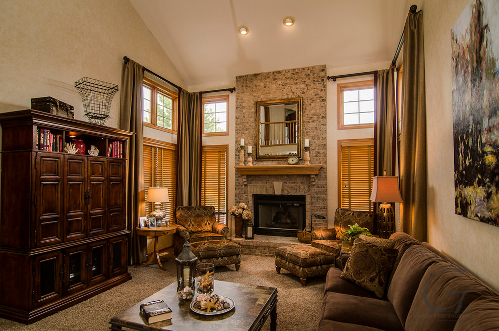 This is an example of a large traditional open concept family room in Chicago with beige walls, carpet, a standard fireplace, a brick fireplace surround and a concealed tv.