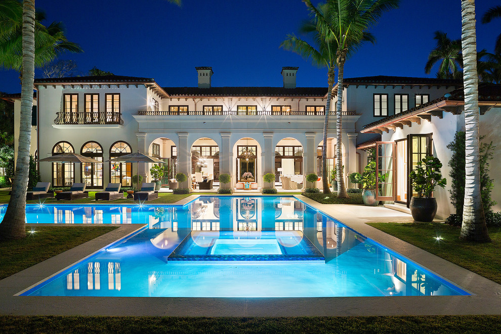 This is an example of a mediterranean two-storey white exterior in Miami.
