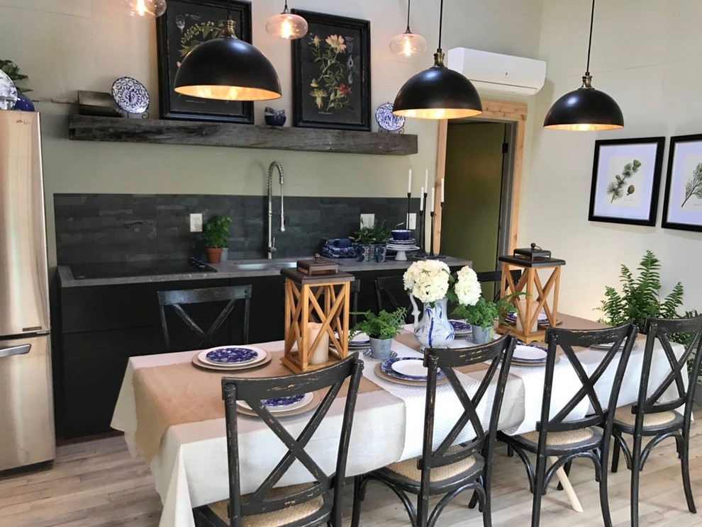Small transitional single-wall light wood floor open concept kitchen photo with an undermount sink, flat-panel cabinets, black cabinets, granite countertops, multicolored backsplash, stainless steel appliances, no island and gray countertops