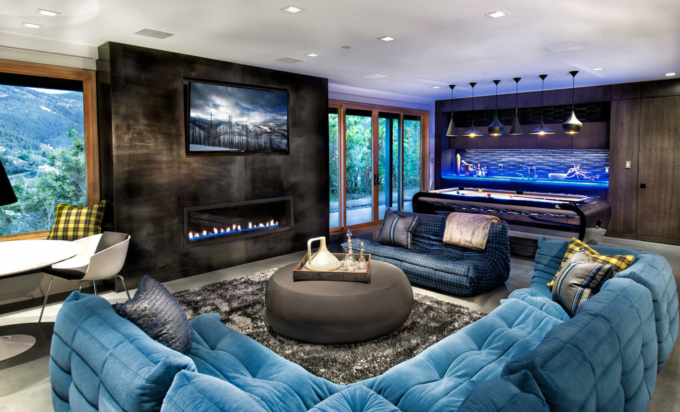 Photo of a contemporary open concept family room in Salt Lake City with a game room, concrete floors and a ribbon fireplace.