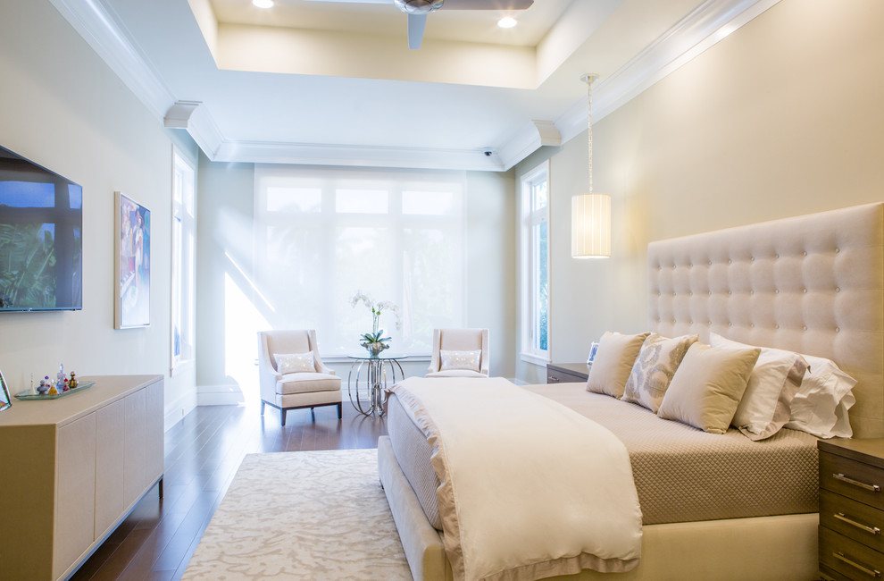 Expansive transitional master bedroom in Miami with beige walls and medium hardwood floors.