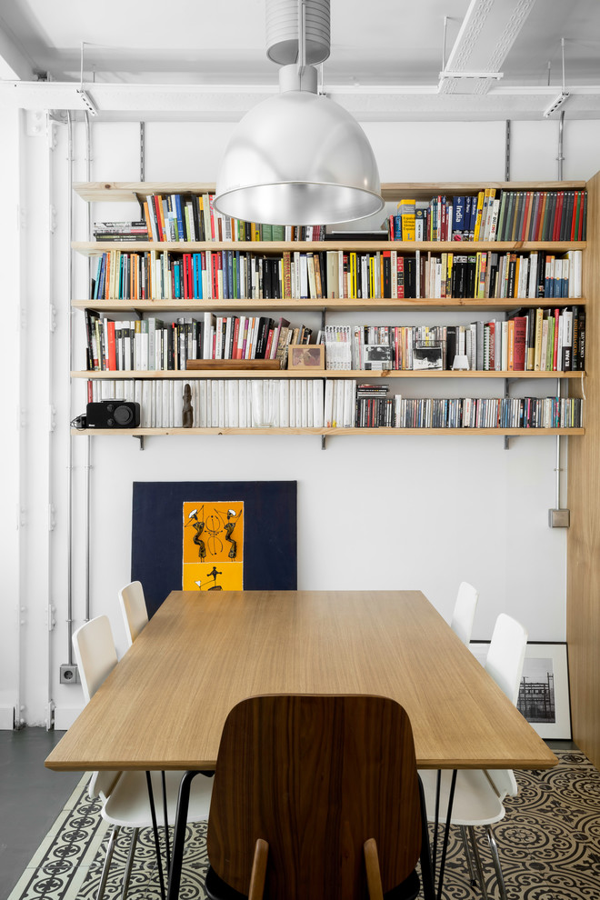 Small industrial open plan dining in Madrid with white walls, ceramic floors and multi-coloured floor.