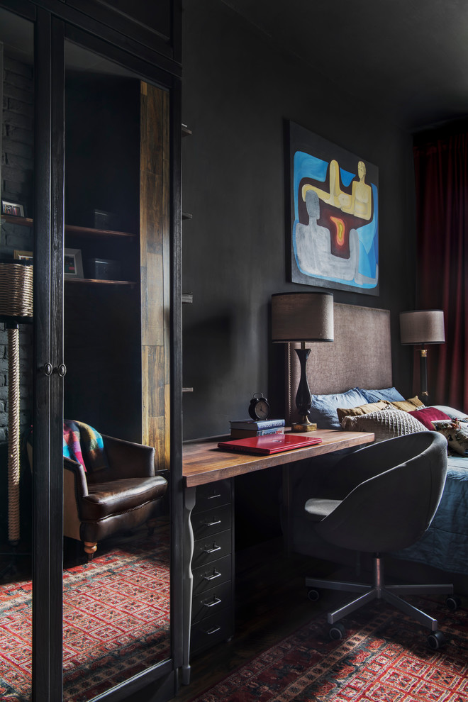 Photo of a mid-sized industrial master bedroom in Moscow with black walls, laminate floors and brown floor.