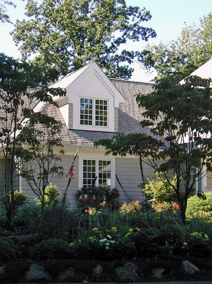 Large traditional two-storey grey exterior in Cleveland with wood siding.