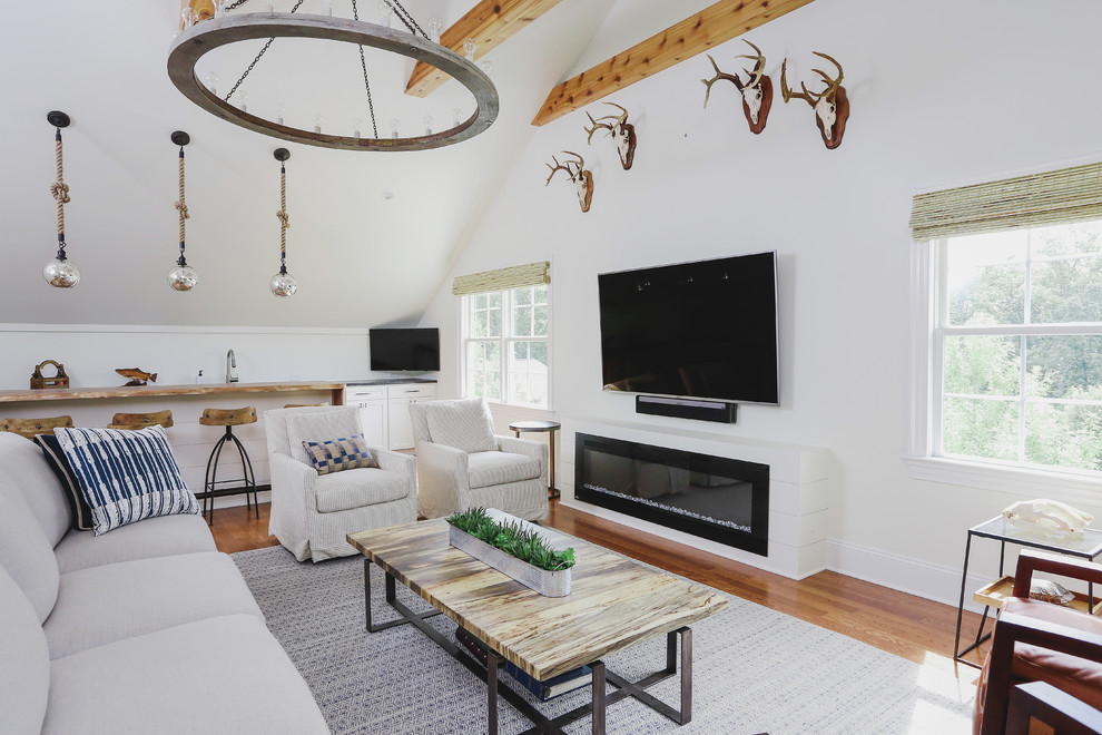 Example of a farmhouse medium tone wood floor and brown floor family room design in Raleigh with a bar, white walls, a ribbon fireplace and a wall-mounted tv