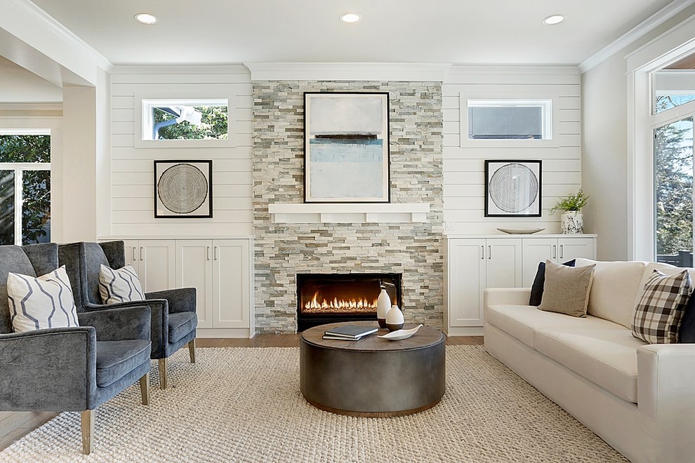 Inspiration for a transitional formal living room in Seattle with white walls, a standard fireplace, a stone fireplace surround and no tv.