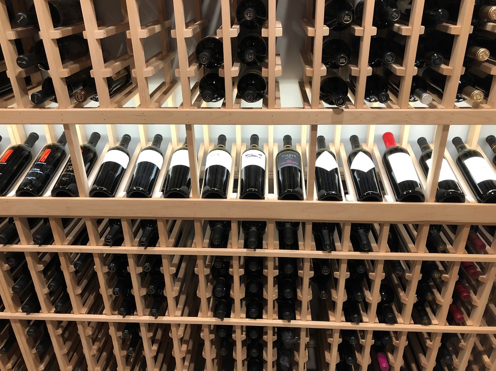Photo of a mid-sized traditional wine cellar in Richmond with storage racks.