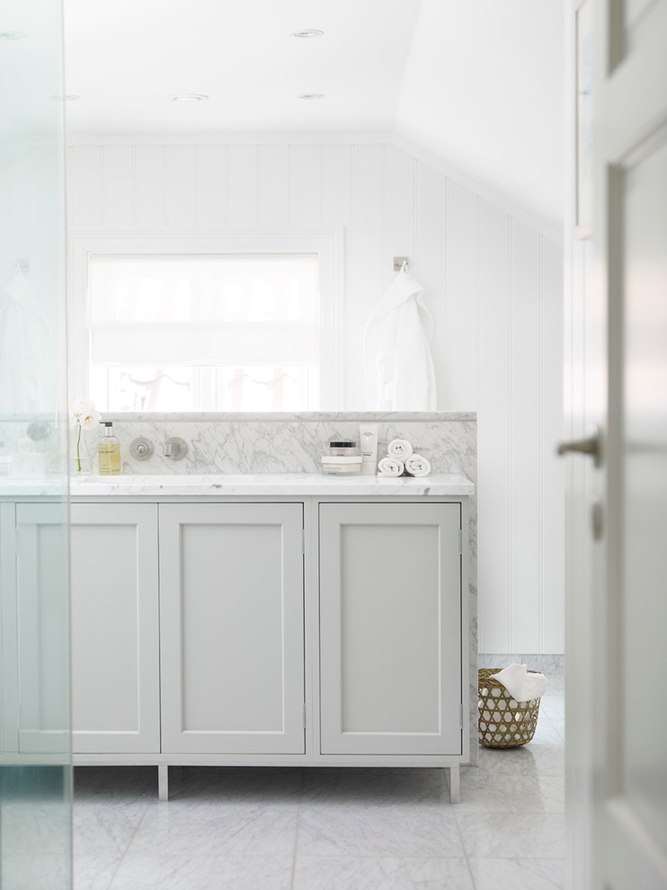 Inspiration for a scandinavian master bathroom in New York with shaker cabinets, grey cabinets, a corner shower, white tile, stone tile, white walls, marble floors, an integrated sink and marble benchtops.