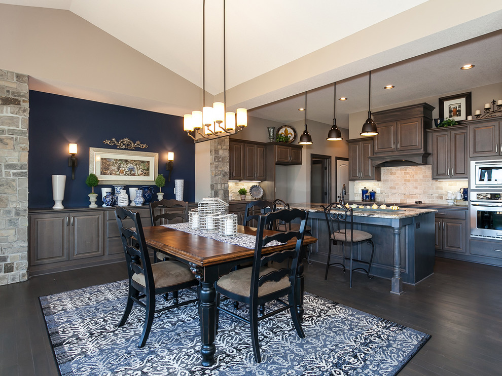 Traditional kitchen/dining combo in Wichita with beige walls and dark hardwood floors.
