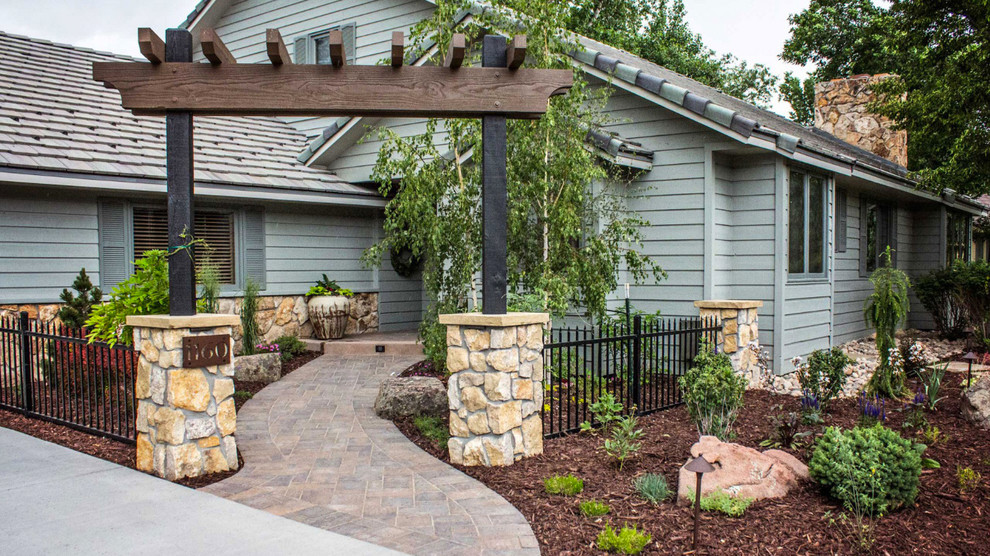 Inspiration for a large transitional front yard partial sun driveway for spring in Denver with concrete pavers.