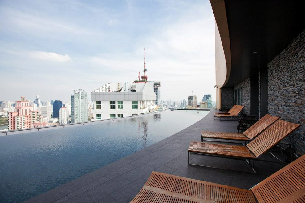 This is an example of a large modern rooftop custom-shaped pool in Miami.