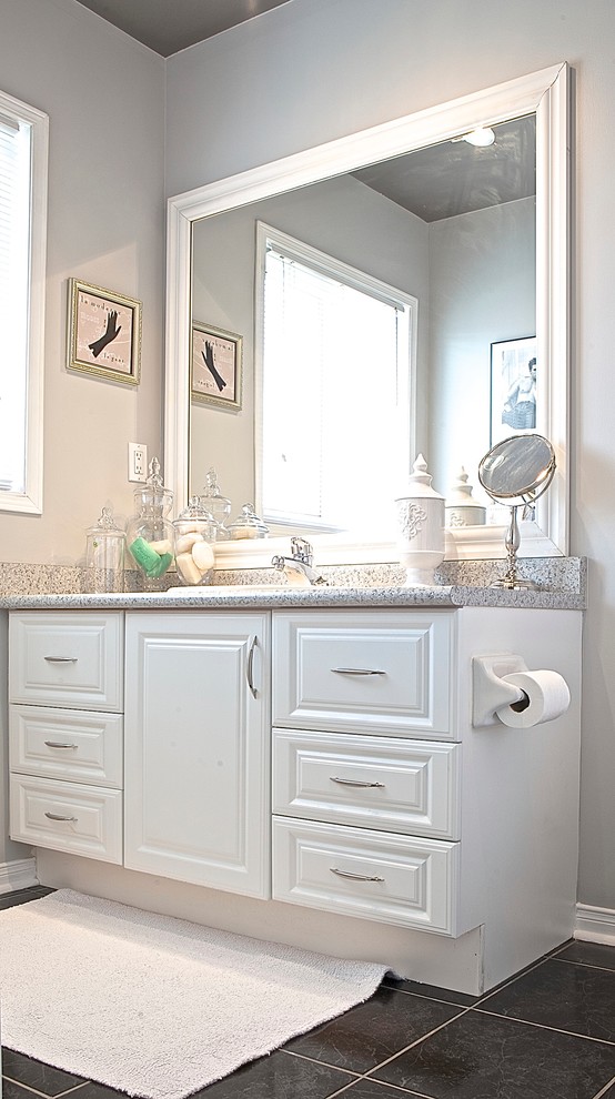 Inspiration for a small transitional master bathroom in Toronto with raised-panel cabinets, white cabinets, laminate benchtops, gray tile, ceramic tile, grey walls and ceramic floors.