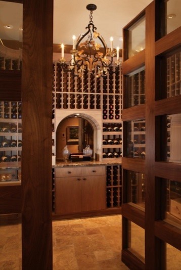 Design ideas for a mid-sized midcentury wine cellar in Phoenix with travertine floors and storage racks.