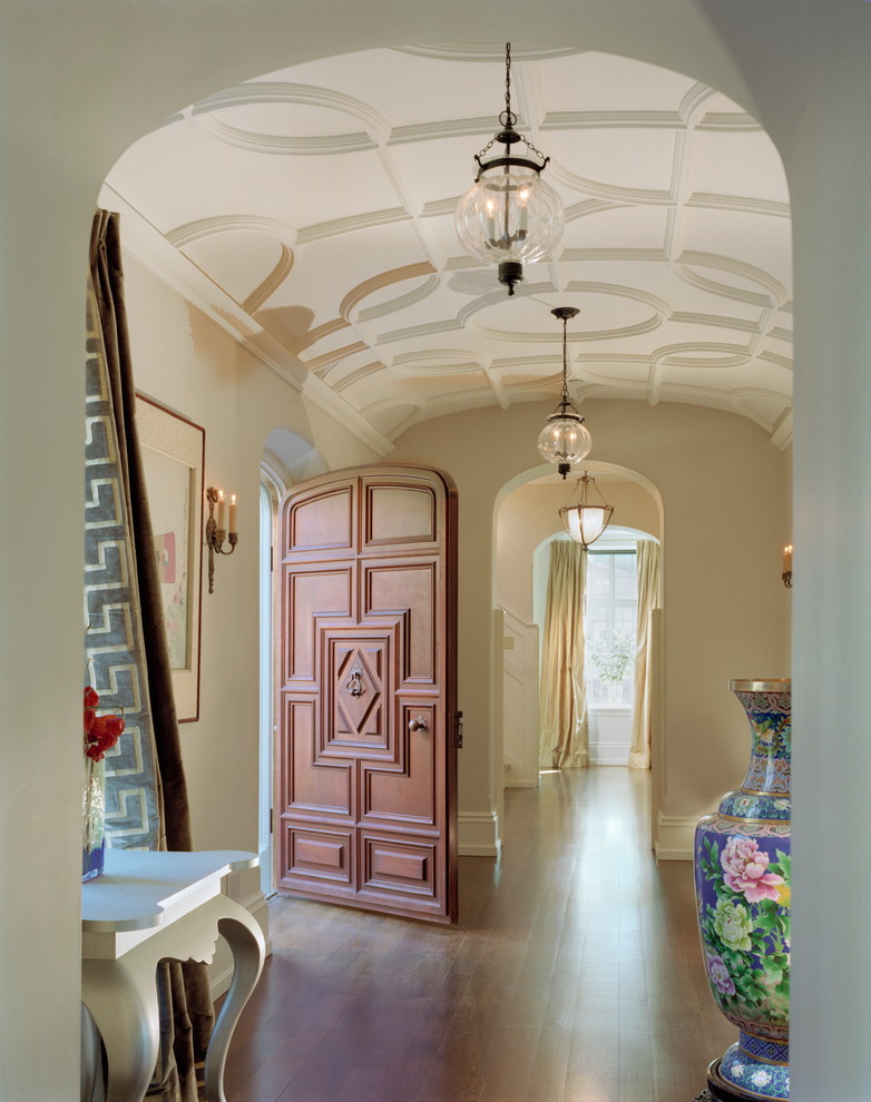 This is an example of an expansive traditional foyer in Philadelphia with beige walls, medium hardwood floors, a single front door, a dark wood front door and beige floor.