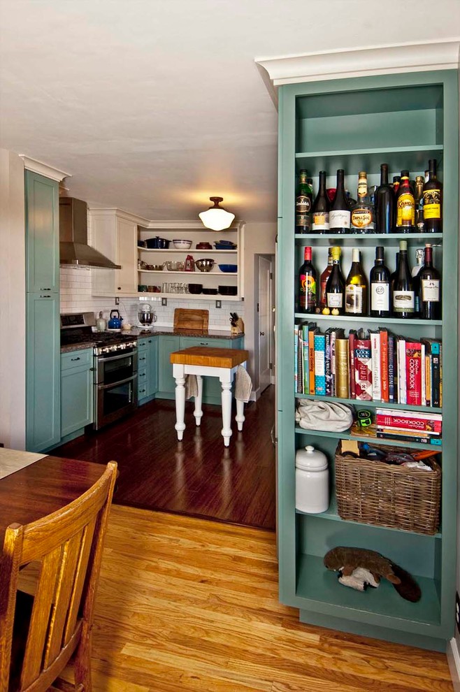 Eat-in kitchen - small transitional u-shaped dark wood floor eat-in kitchen idea with a farmhouse sink, shaker cabinets, green cabinets, granite countertops, yellow backsplash, stainless steel appliances and no island