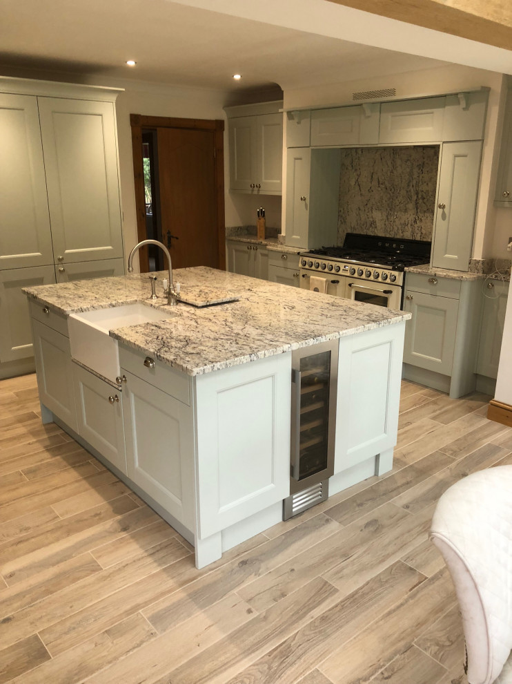Inspiration for a large country kitchen in Other with a farmhouse sink, shaker cabinets, blue cabinets, granite benchtops, grey splashback, granite splashback, porcelain floors, with island and grey benchtop.