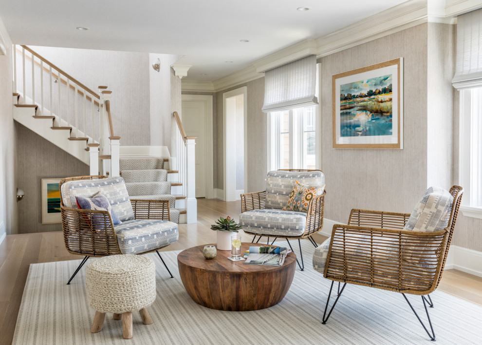 Inspiration for a beach style living room in New York with beige walls and light hardwood floors.