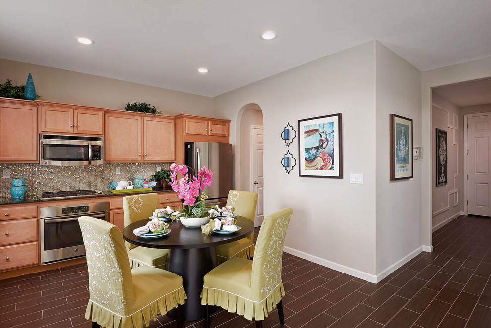 Open concept kitchen - transitional brown floor open concept kitchen idea with medium tone wood cabinets, granite countertops, multicolored backsplash, mosaic tile backsplash and stainless steel appliances