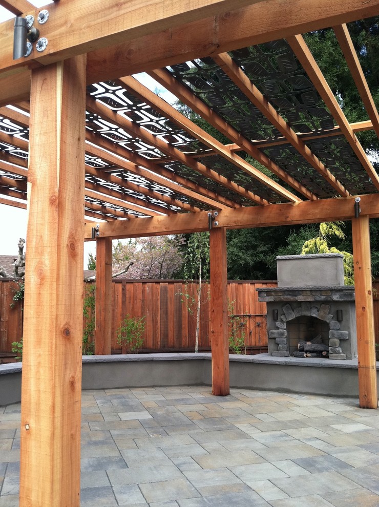 Large traditional backyard patio in San Francisco with a fire feature, natural stone pavers and a pergola.