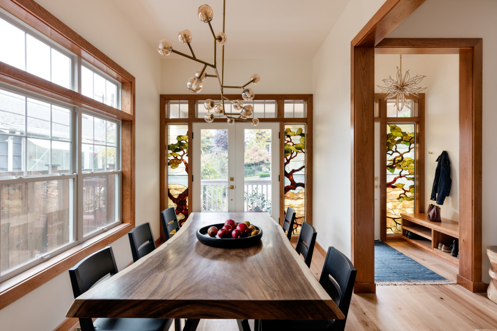 Example of a transitional light wood floor and beige floor dining room design in Seattle with beige walls
