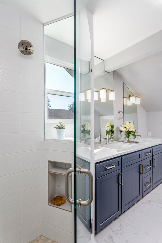 Inspiration for a mid-sized transitional master bathroom in Portland with shaker cabinets, blue cabinets, an alcove shower, white tile, white walls, ceramic floors, a drop-in sink, engineered quartz benchtops, white floor, a hinged shower door and white benchtops.