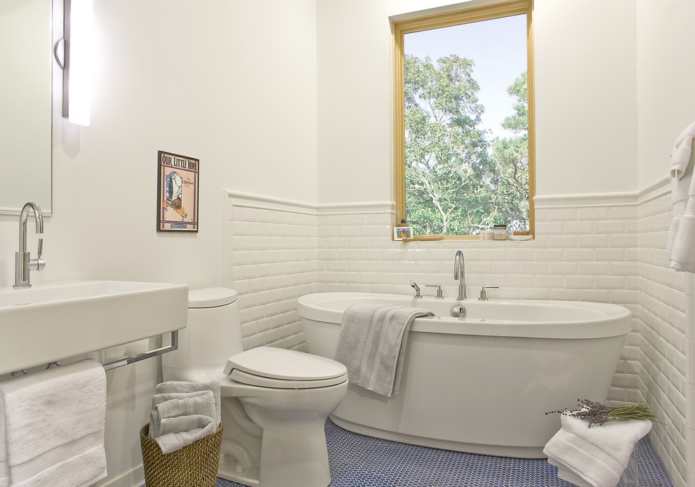 Photo of a transitional bathroom in Boston with a freestanding tub and blue floor.