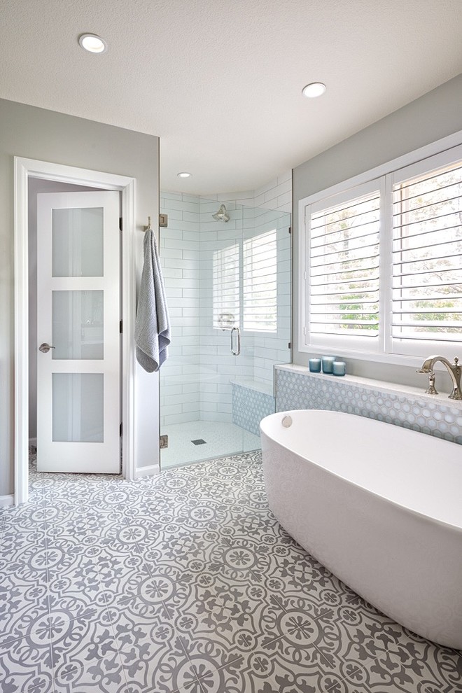 Mid-sized contemporary master bathroom in Denver with flat-panel cabinets, brown cabinets, a freestanding tub, a corner shower, gray tile, ceramic tile, grey walls, cement tiles, a drop-in sink, quartzite benchtops, white floor, a hinged shower door and white benchtops.