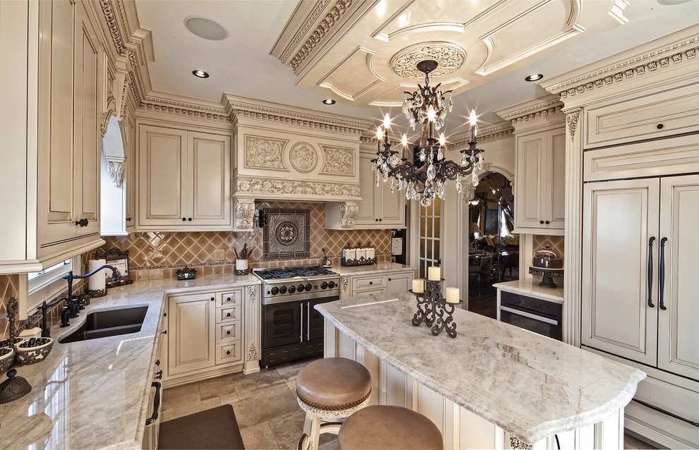 This is an example of a large traditional u-shaped open plan kitchen in Philadelphia with a single-bowl sink, raised-panel cabinets, beige cabinets, marble benchtops, multi-coloured splashback, ceramic splashback, stainless steel appliances, porcelain floors and with island.