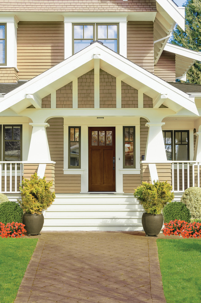 Inspiration for an arts and crafts two-storey beige exterior in Other with vinyl siding.