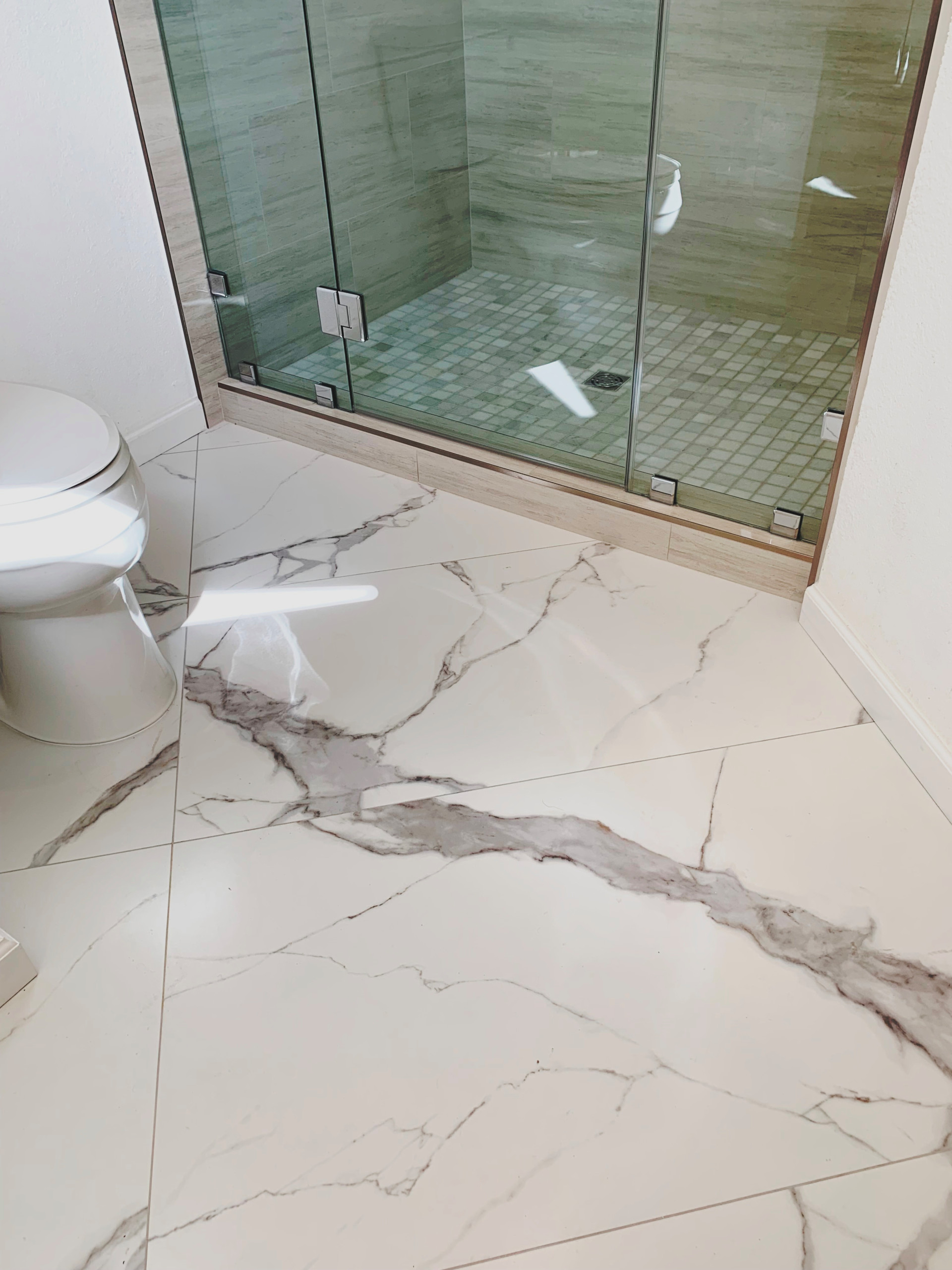 Large format ceramic tile floor & shower walls.
