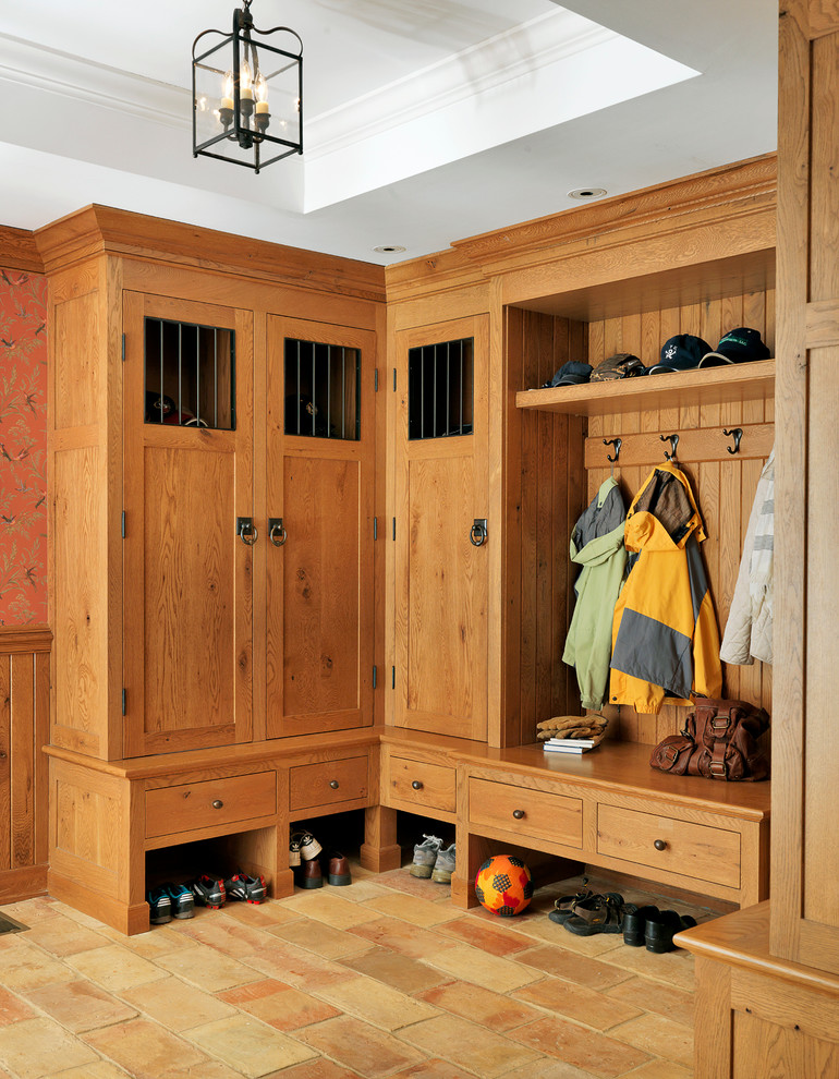 Photo of a large traditional mudroom in Boston with white walls.