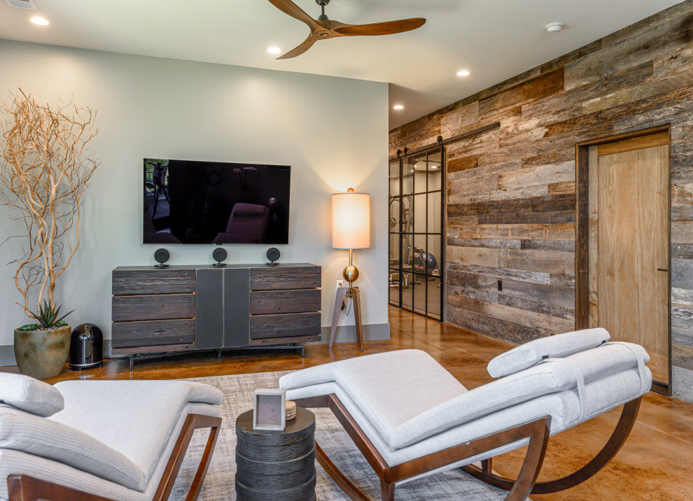 Inspiration for a mid-sized rustic concrete floor and brown floor basement remodel with gray walls