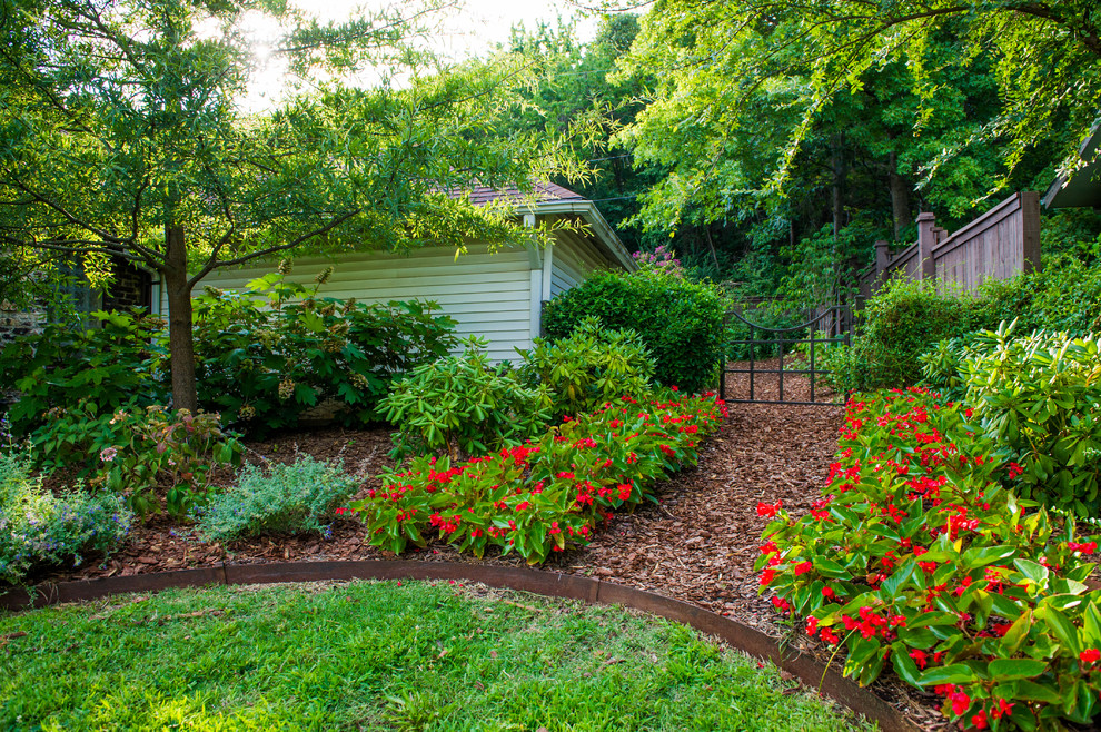 Traditional backyard garden in Little Rock with mulch.